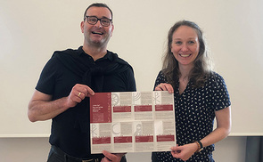 Die Theolog:innen Gudrun Becker und Stefan Schlager von der Diözese Linz mit dem Folder „Frohes Fest“. 